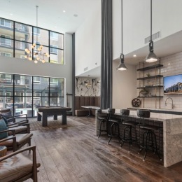 a clubroom with a tv, tables and chairs