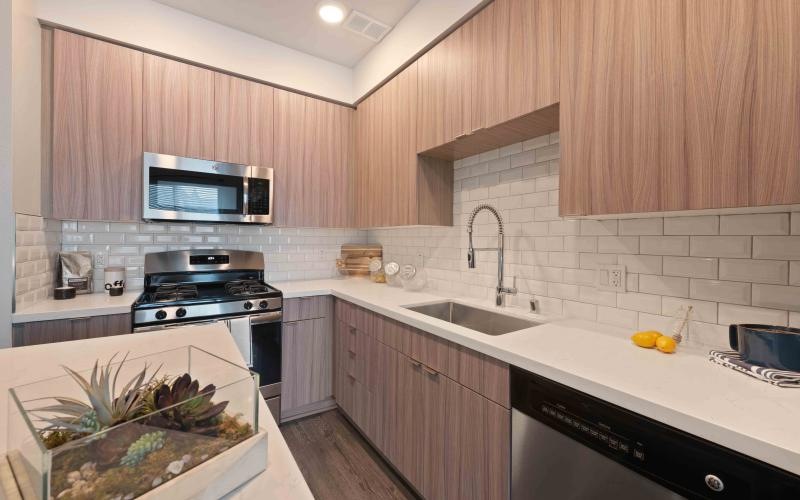 a kitchen with wooden cabinets